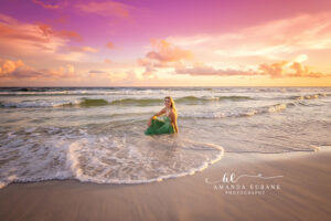 Rosemary Beach senior photographer captures a 30A sunset surf portrait in a blush pink gown.