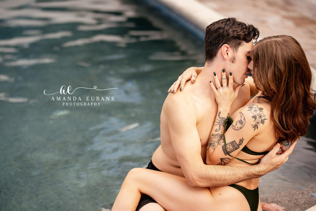 Vacationing couple in a tender embrace beside a secluded pool on Florida's 30A