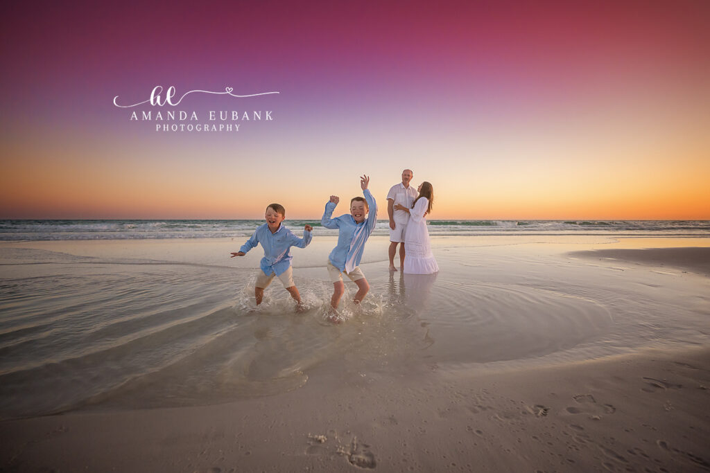 Williams family of four standing together at the close of golden hour in coordinated whites and soft blues on 30A in Santa Rosa Beach.