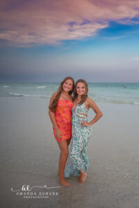 Miss P smiles softly toward the Gulf as pastel sunset light washes over the 30A shoreline