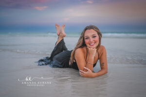 Miss P stands tall on the white sand of Santa Rosa Beach as pastel sky stretches above her