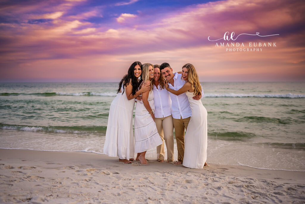 Close family hug at twilight on the 30A beach