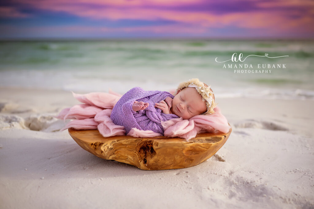 Destin newborn photographer — Miss Dorthy sleeping in a wooden bowl on the white-sand beach