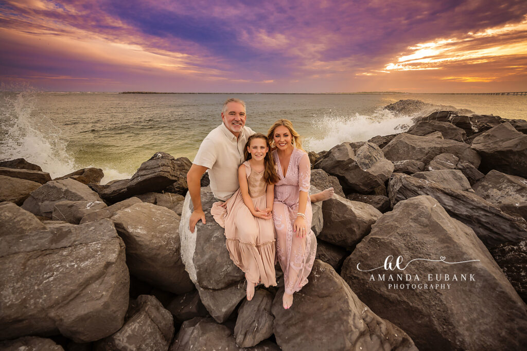 Destin Jetties family photographer — C family gathered on the East Pass jetty rocks at sunset