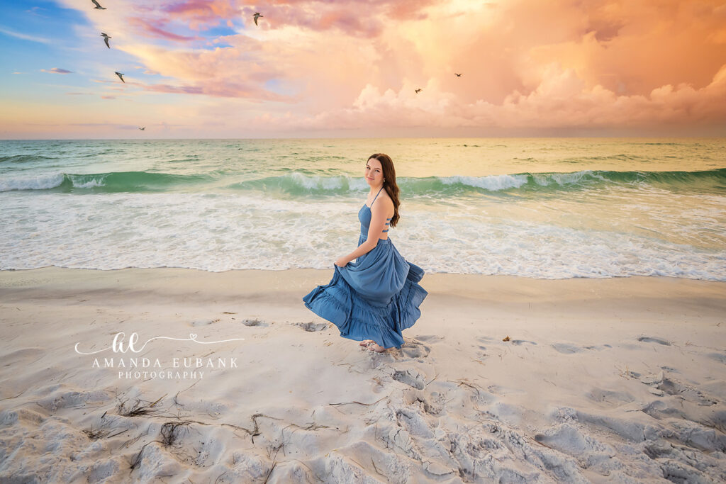 Senior Liz kneels thoughtfully in the wash of incoming Destin surf at sunrise.