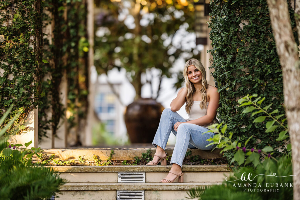 Rosemary Beach senior photographer captures portrait of senior girl on the brick walkway near palmettos in Rosemary Beach, FL