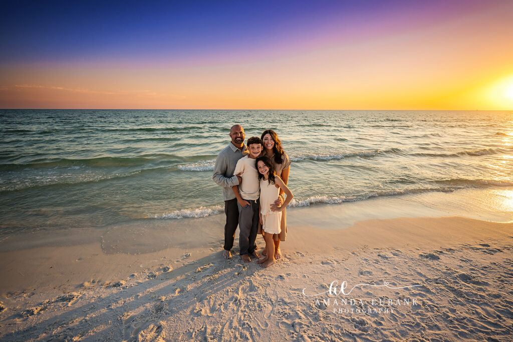 Destin family sunset session — silhouette of the M Family against an orange Destin sky