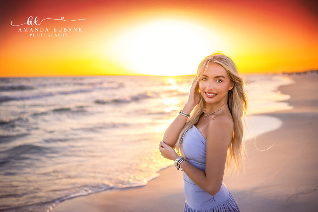 Senior girl in white dress during Seaside sunset senior photography session on 30A, captured by a Seaside Florida photographer.