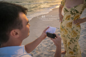 Carillon Beach photographer captures the boyfriend reading handwritten vows from inside the open ring box.