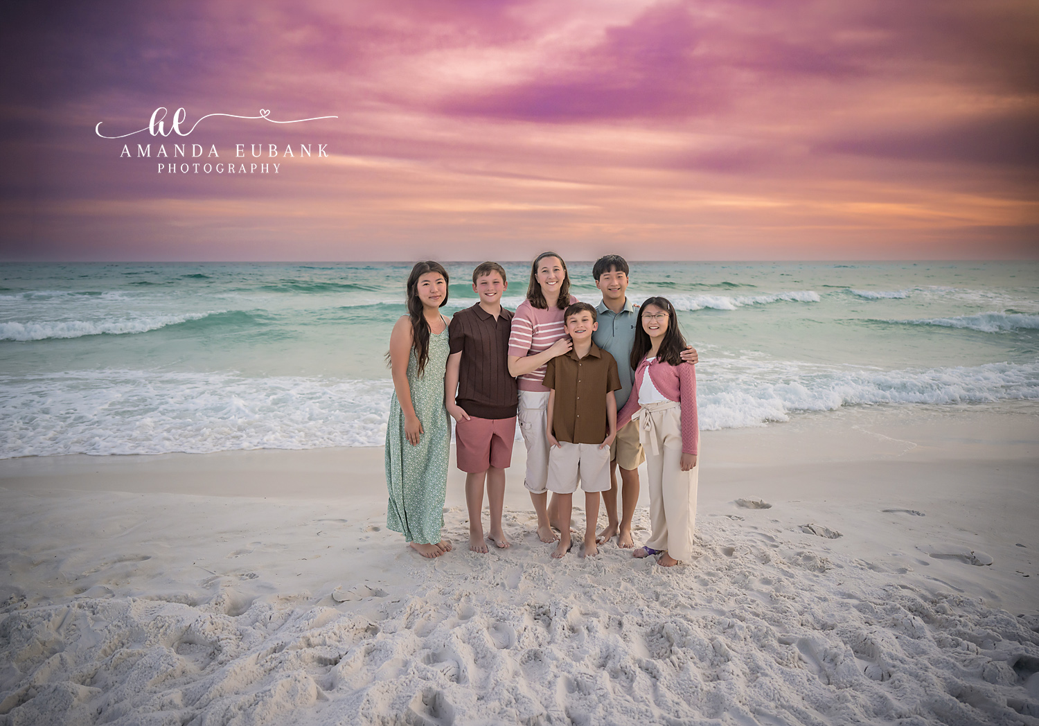 Miramar Beach Mother and Five Kids Sunset Portrait | Miramar Beach FL Family Photographer Mother surrounded by her five children on Miramar Beach FL at sunset with the Gulf surf and a vivid pink and purple sky behind them