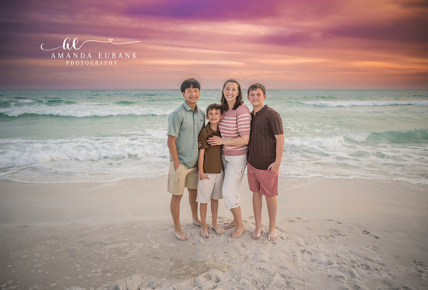 Miramar Beach Big Sister with Brothers Sunset Portrait | Miramar Beach FL Family Photographer Older sister in a pink striped tee with her three brothers in coordinated coastal outfits on Miramar Beach FL at sunset with the Gulf surf and a pink orange sky