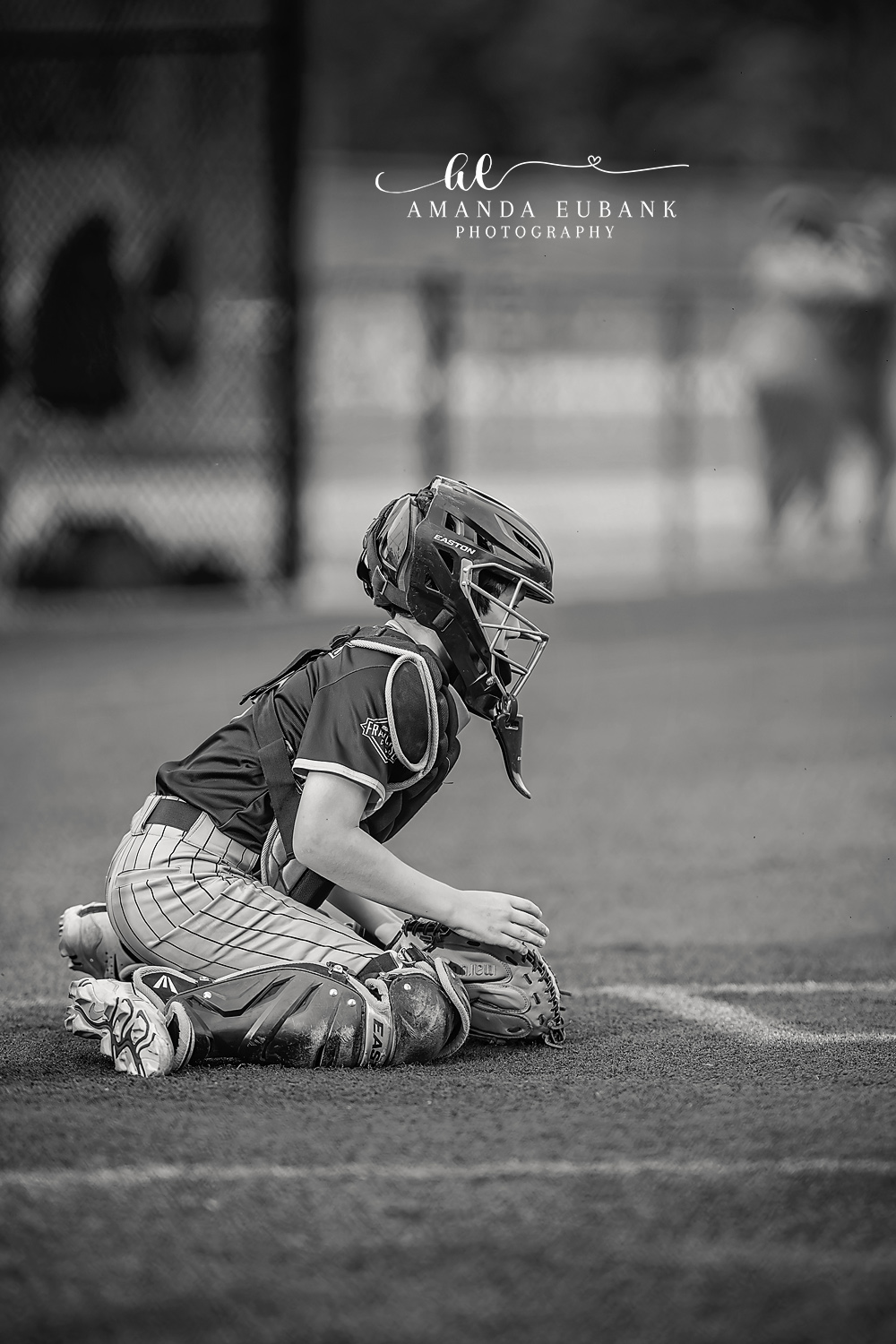 Catcher Kneeling at Home Plate | Hoover AL Travel Baseball Photographer Black and white quiet moment of a Power 11U Kilcrease catcher kneeling in the dirt beside home plate in full gear, gathering himself between innings during a Hoover, Alabama tournament game.