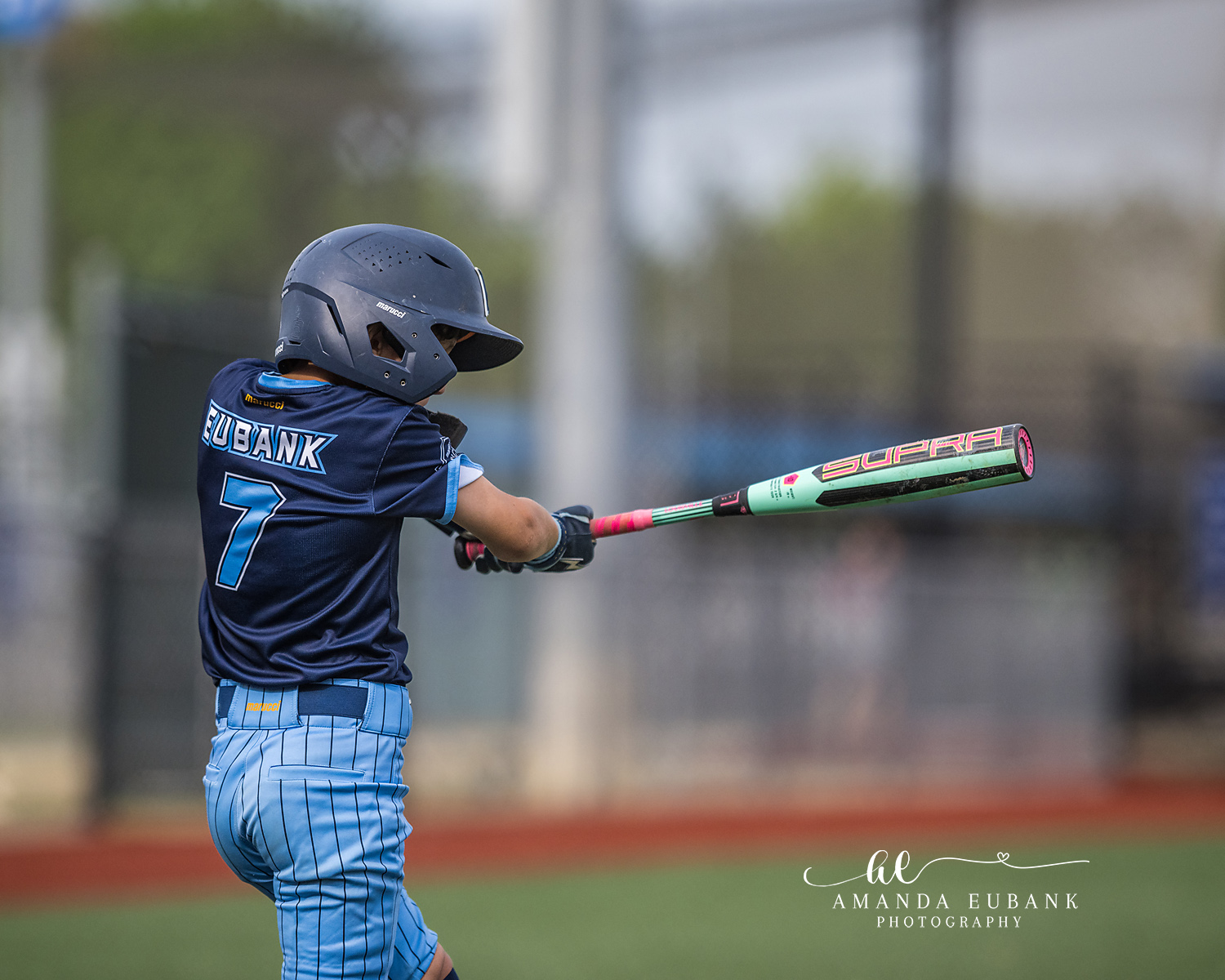 Eubank Number 7 Bat Extension | Hoover AL Travel Baseball Photographer Power Kilcrease 11U batter Eubank number 7 extends his mint and pink Supra bat through contact viewed from behind during a Hoover, Alabama tournament game.