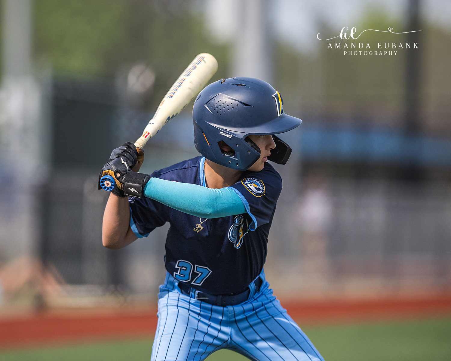 Batter Number 37 Wood Bat Coil | Hoover AL Travel Baseball Photographer Power Kilcrease 11U batter number 37 holds his wood bat coiled high in his stance with a light blue compression sleeve and Power helmet during a Hoover, Alabama tournament game.