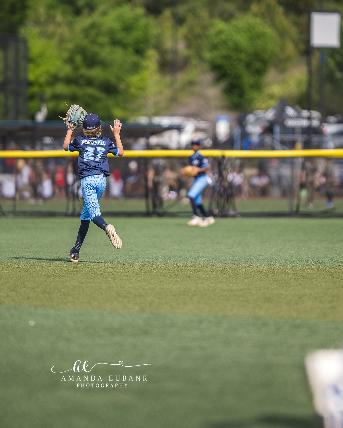 Beauford Number 27 Tracking Fly Ball | Hoover AL Travel Baseball Photographer Power Kilcrease 11U outfielder Beauford number 27 sprints across the grass with glove raised tracking a fly ball during a Hoover, Alabama travel baseball tournament game.