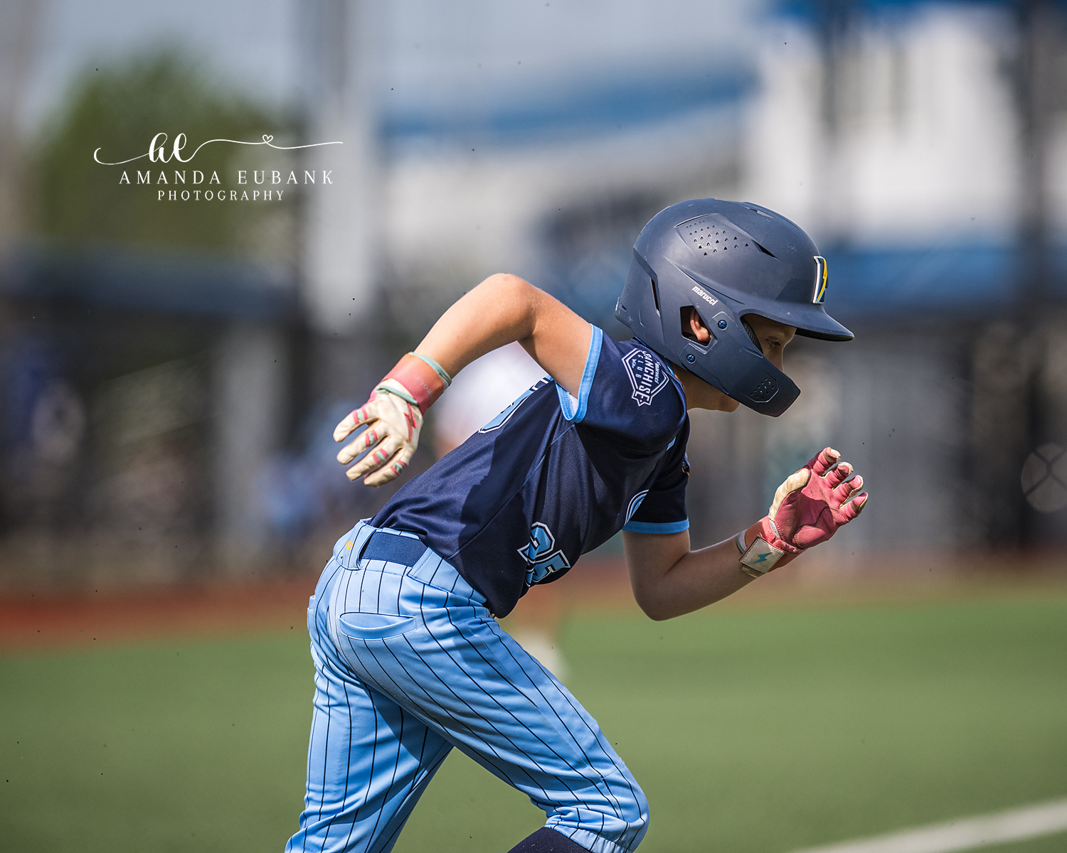 Baserunner Explosive Take-Off | Hoover AL Travel Baseball Photographer Tight profile shot of a Power Kilcrease 11U baserunner exploding off the bag in pink batting gloves and navy helmet during a Hoover, Alabama travel baseball tournament game.