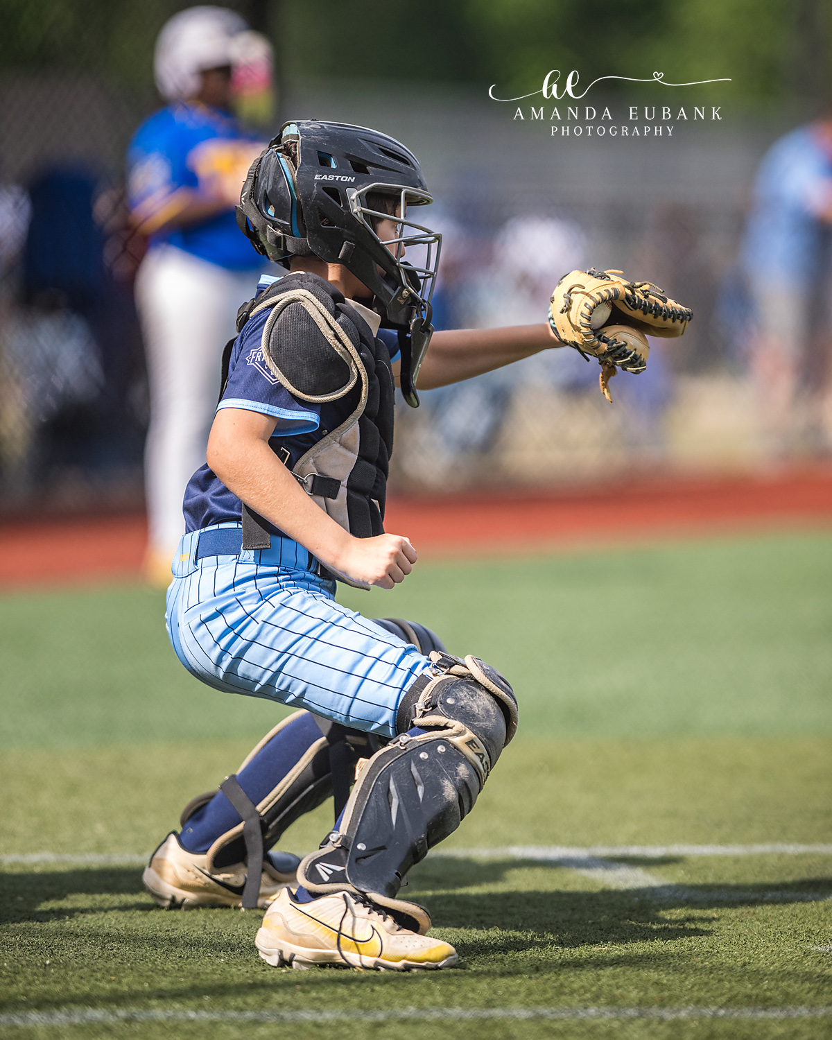 Catcher Setting Target Mitt Forward | Hoover AL Travel Baseball Photographer Power Kilcrease 11U catcher in deep crouch sets a target with his tan mitt extended forward as the opposing batter sets up in the box during a Hoover, Alabama tournament game.