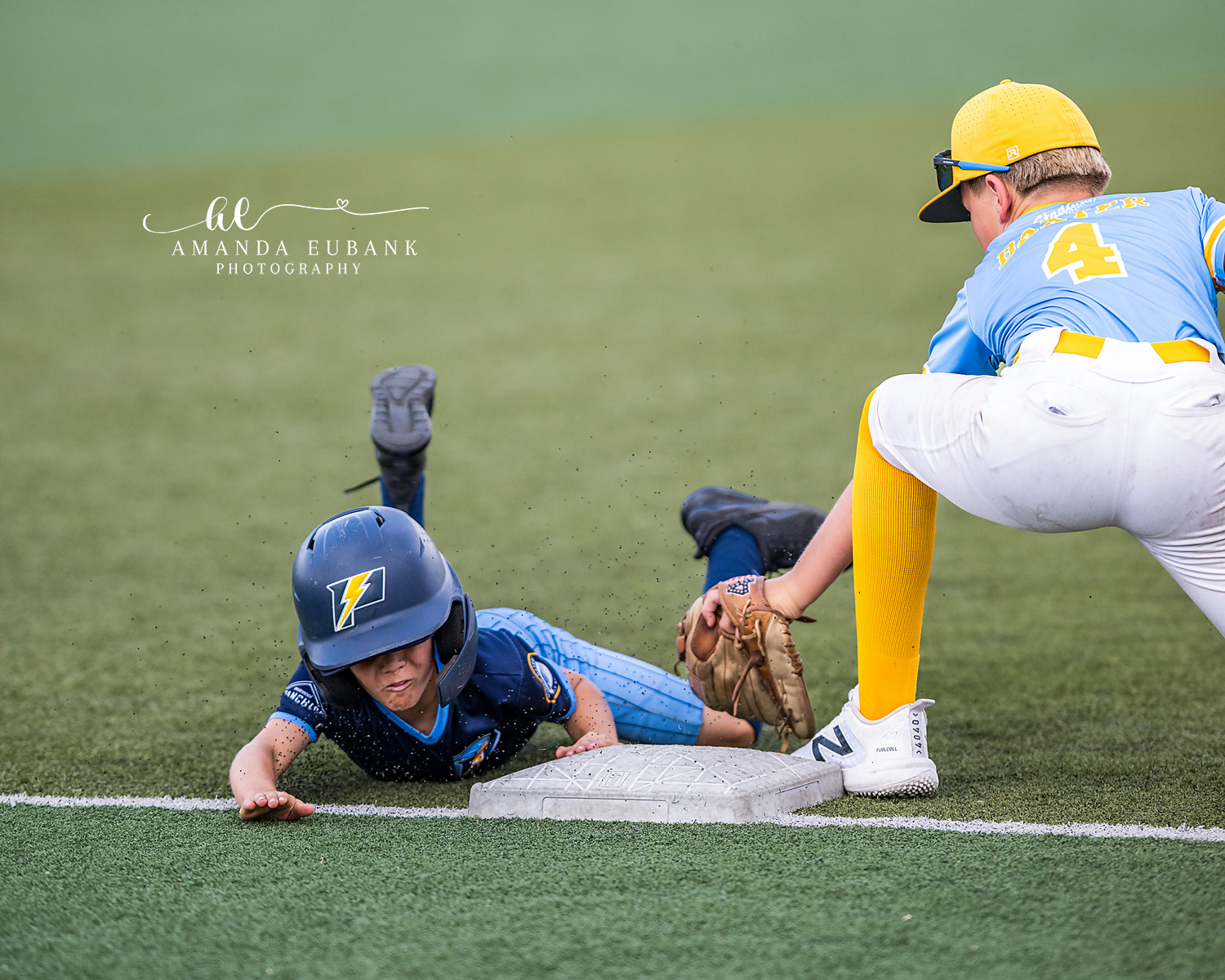 Headfirst Slide Tag Play | Hoover AL Travel Baseball Photographer Power Kilcrease 11U baserunner slides headfirst into the bag as an opposing infielder number 4 in light blue and yellow drops the tag during a Hoover, Alabama tournament game.