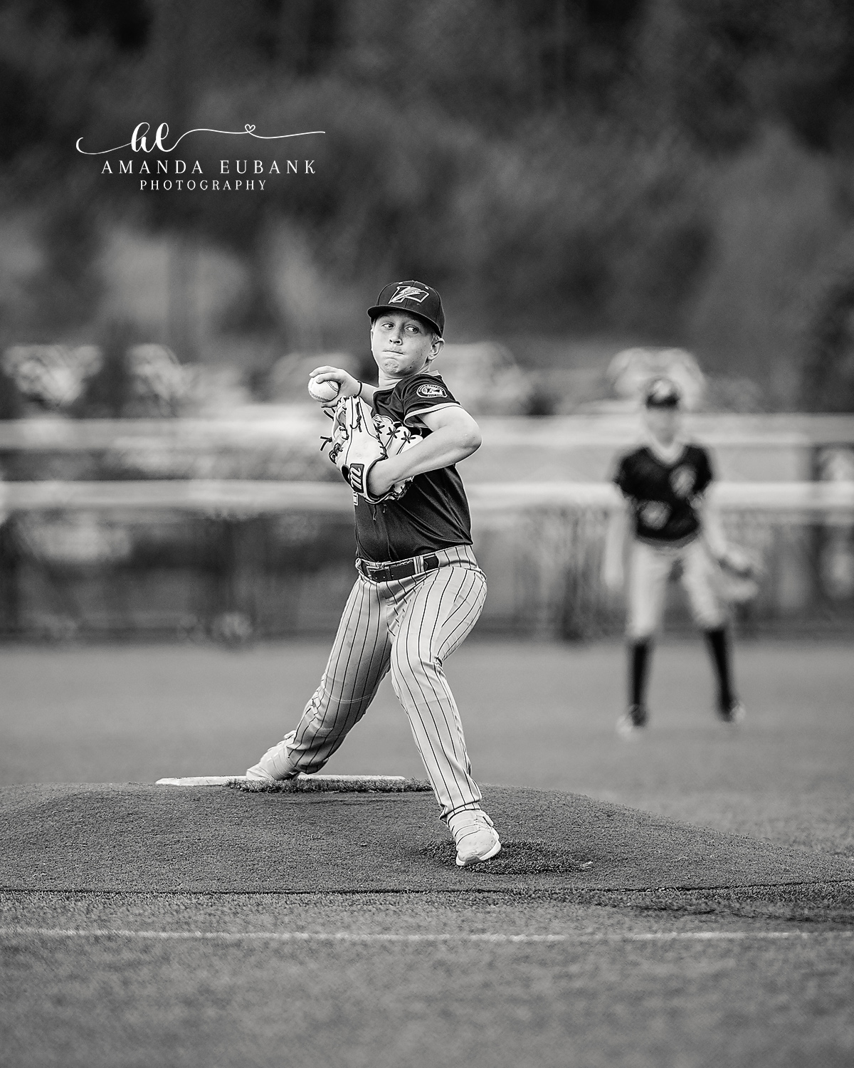 Pitcher Black Jersey Loaded BW | Hoover AL Travel Baseball Photographer Black and white image of a Power Kilcrease 11U pitcher in the team black jersey reaching peak loaded position on the dirt mound during a Hoover, Alabama travel baseball tournament game.