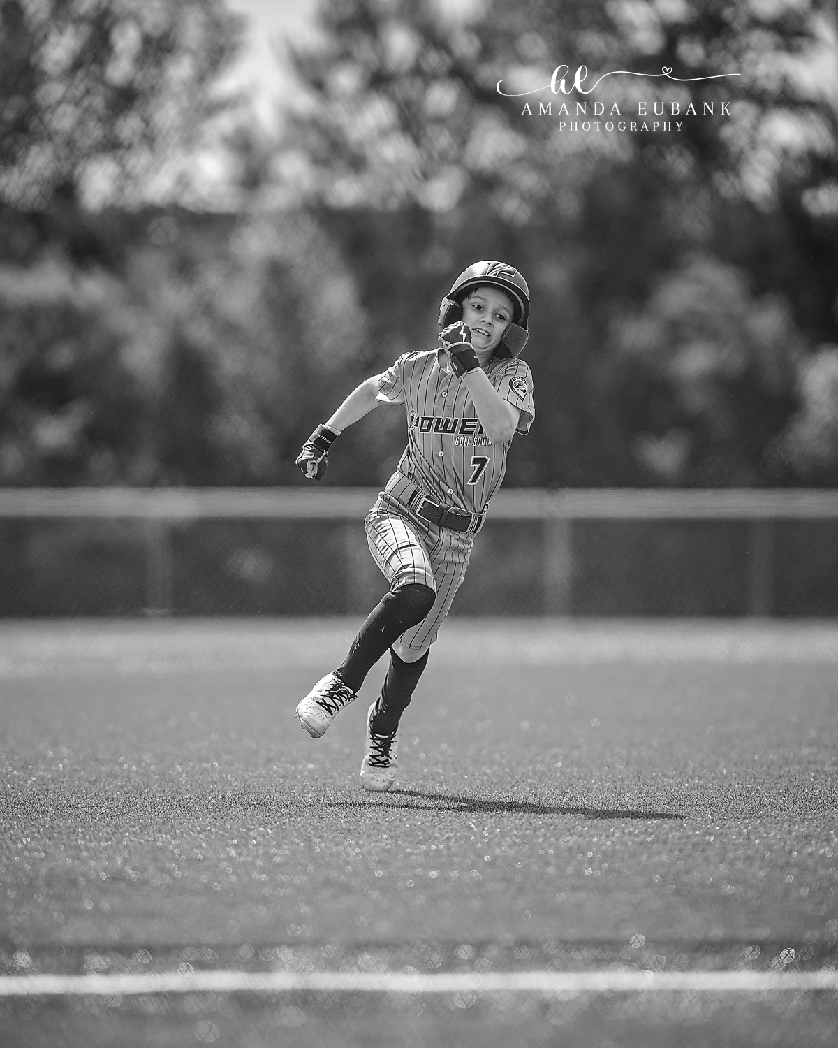 Kilcrease 11U Sprint Between Bases Black and White | Power Baseball Gulf South Hoover AL Black and white image of Kilcrease 11U number 7 sprinting between bases in a Power Baseball pinstripe jersey at a Hoover AL tournament