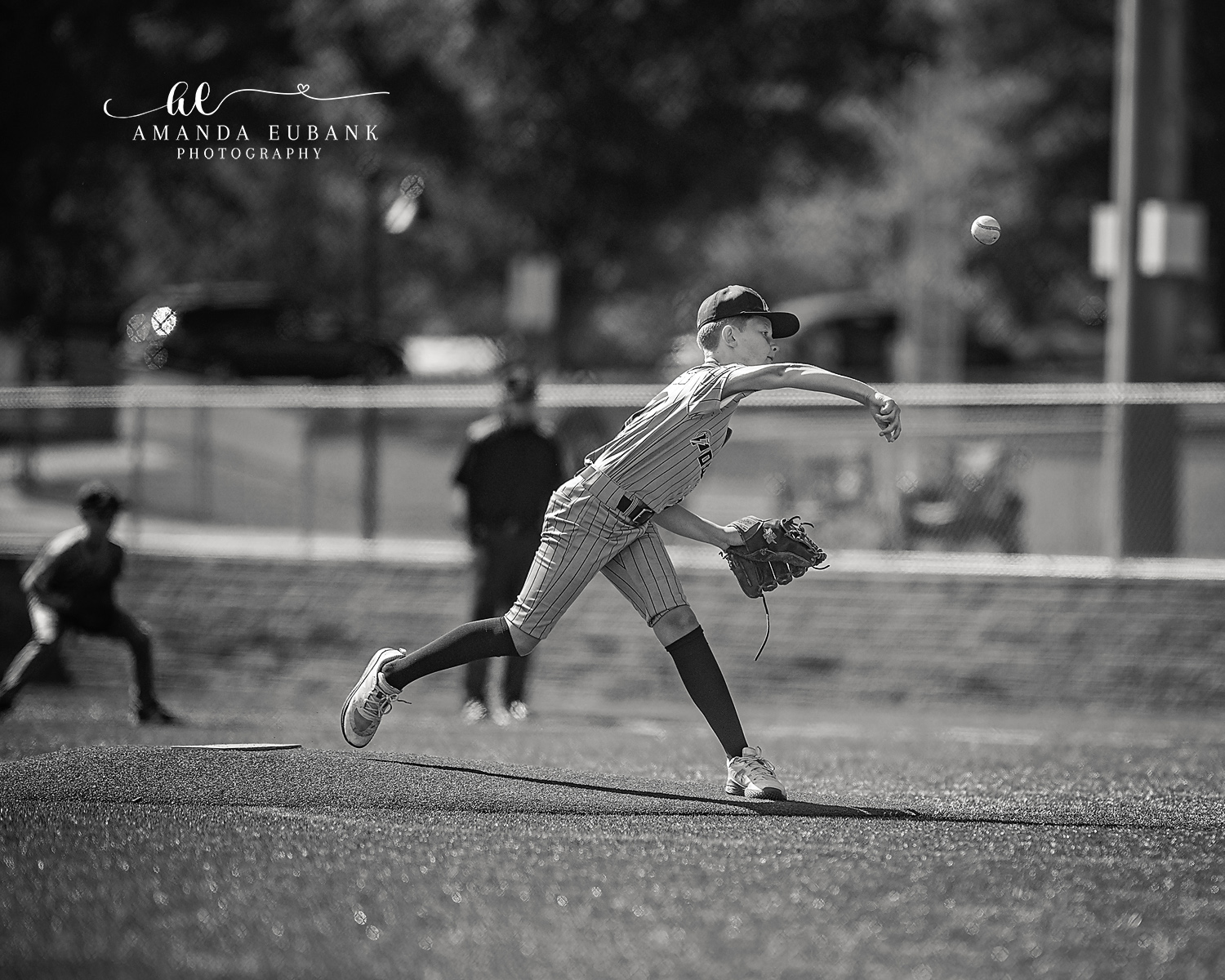 Kilcrease 11U Pitch in Flight Black and White | Power Baseball Gulf South Hoover AL Black and white photo of Kilcrease 11U Power Baseball pitcher delivering a pitch with the ball in flight at a Hoover AL tournament