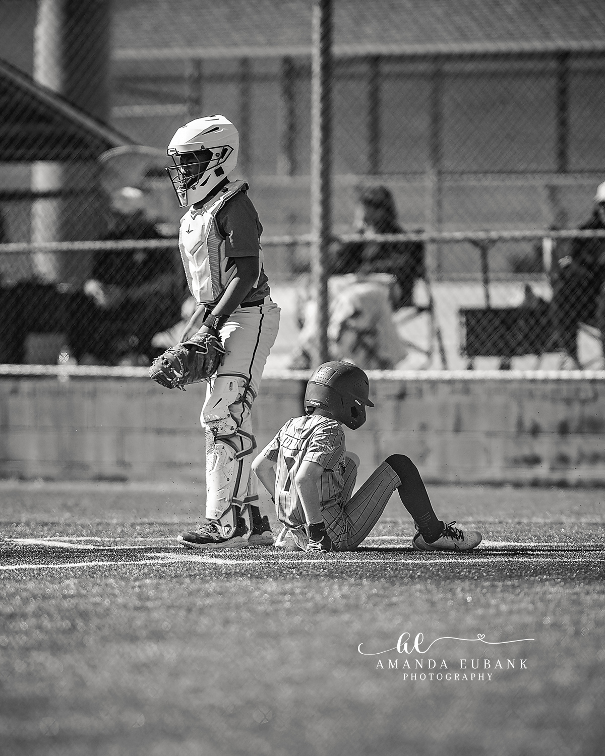 Kilcrease 11U Catchers in Full Gear Black and White | Power Baseball Gulf South Hoover AL Black and white image of two Kilcrease 11U Power Baseball catchers in full gear pausing near home plate at a Hoover AL tournament