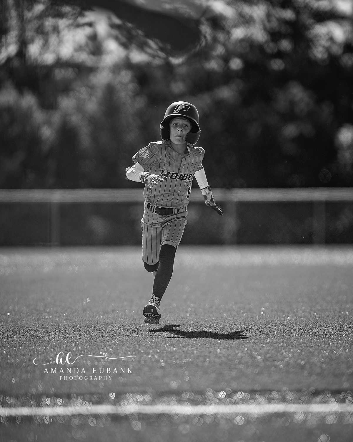 Kilcrease 11U Solo Sprint Black and White | Power Baseball Gulf South Hoover AL Black and white image of a Kilcrease 11U Power Baseball runner sprinting in pinstripe jersey at a Hoover AL tournament