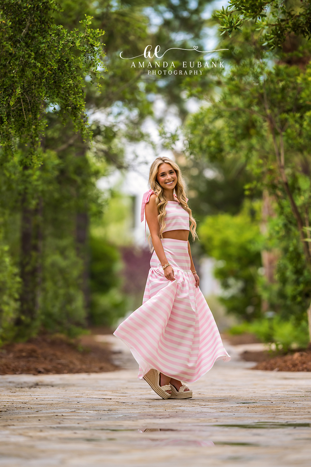 Senior in Motion on Alys Beach Walkway | Senior Photographer in Alys Beach Senior walking with skirt in motion on a brick Alys Beach walkway, by Senior Photographer in Alys Beach Amanda Eubank.
