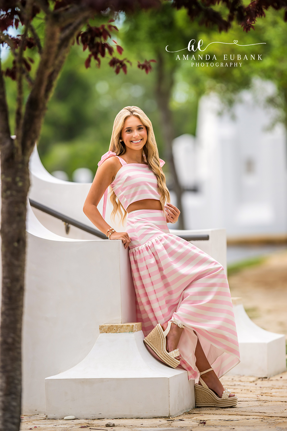 Architectural Detail Senior Portrait | Alys Beach Senior Photographer Senior in a pink-striped two-piece beside a white Alys Beach architectural detail, by Alys Beach Senior Photographer Amanda Eubank.