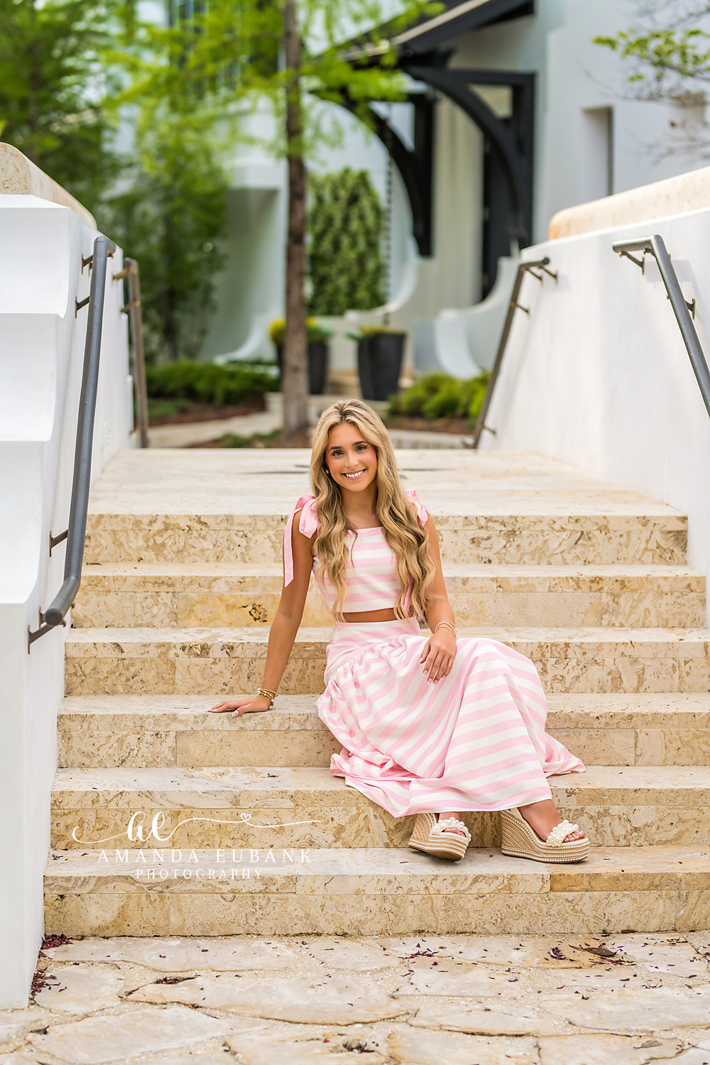 Stone Steps Senior Sitting in Alys Beach | Senior Photographer in Alys Beach Senior in a pink-striped two-piece seated on stone steps in Alys Beach, by Senior Photographer in Alys Beach Amanda Eubank.
