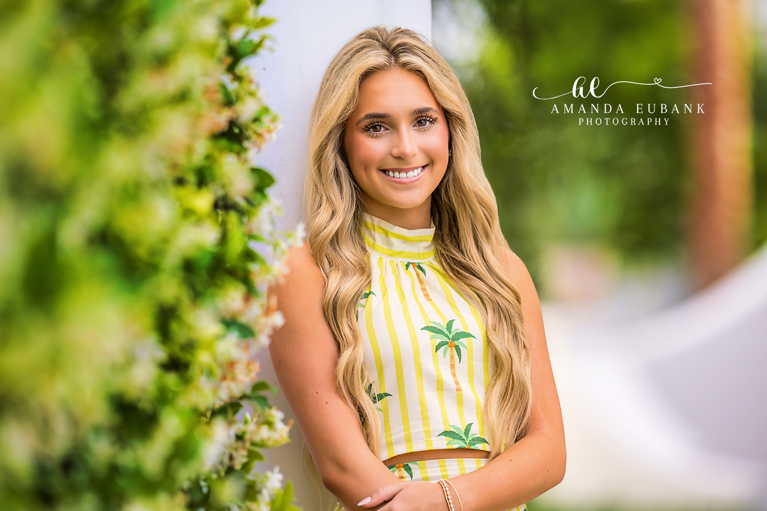 Floral Close-Up Senior Portrait in Alys Beach | Alys Beach Photographer Close-up of a smiling senior with white blooms and greenery in Alys Beach, by Alys Beach Photographer Amanda Eubank.