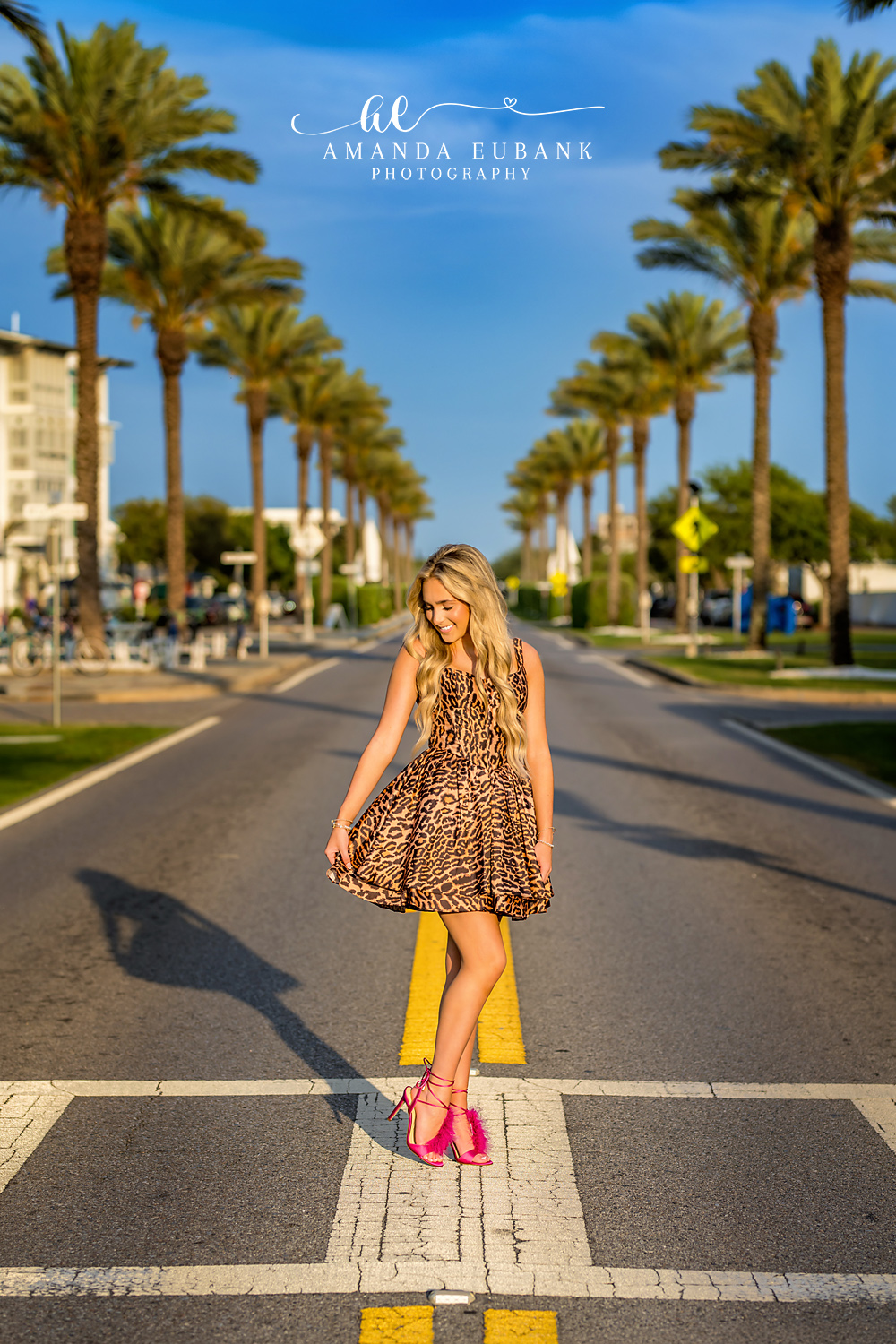 Candid Senior Moment on Alys Beach Boulevard | Senior Photographer in Alys Beach Candid senior portrait with hair flowing on the palm-lined Alys Beach boulevard, by Senior Photographer in Alys Beach Amanda Eubank.