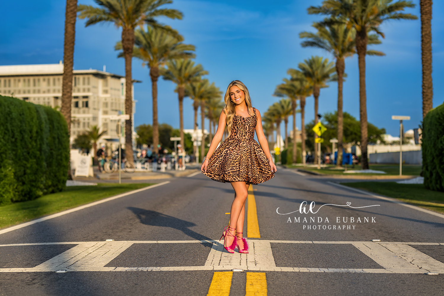 Palm Boulevard Senior Portrait | Alys Beach Senior Photographer Senior in a leopard mini dress on the palm-lined Alys Beach boulevard, by Alys Beach Senior Photographer Amanda Eubank.