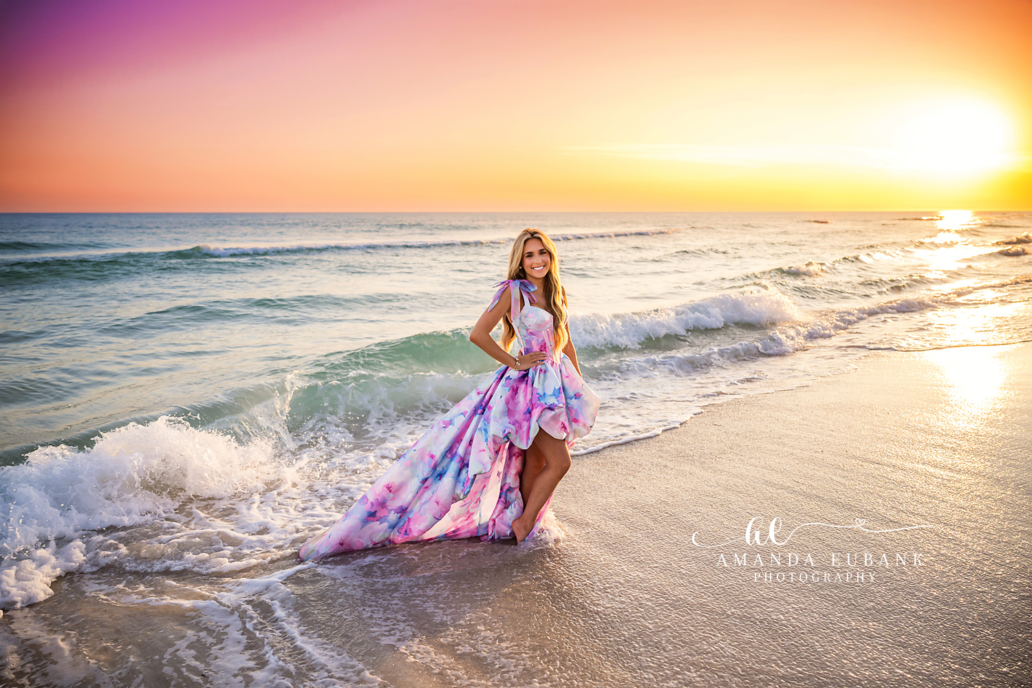 Sunset Surf Senior Portrait | Photographer in Alys Beach Senior in a watercolor pastel gown standing in the surf at sunset, photographed by Photographer in Alys Beach Amanda Eubank.