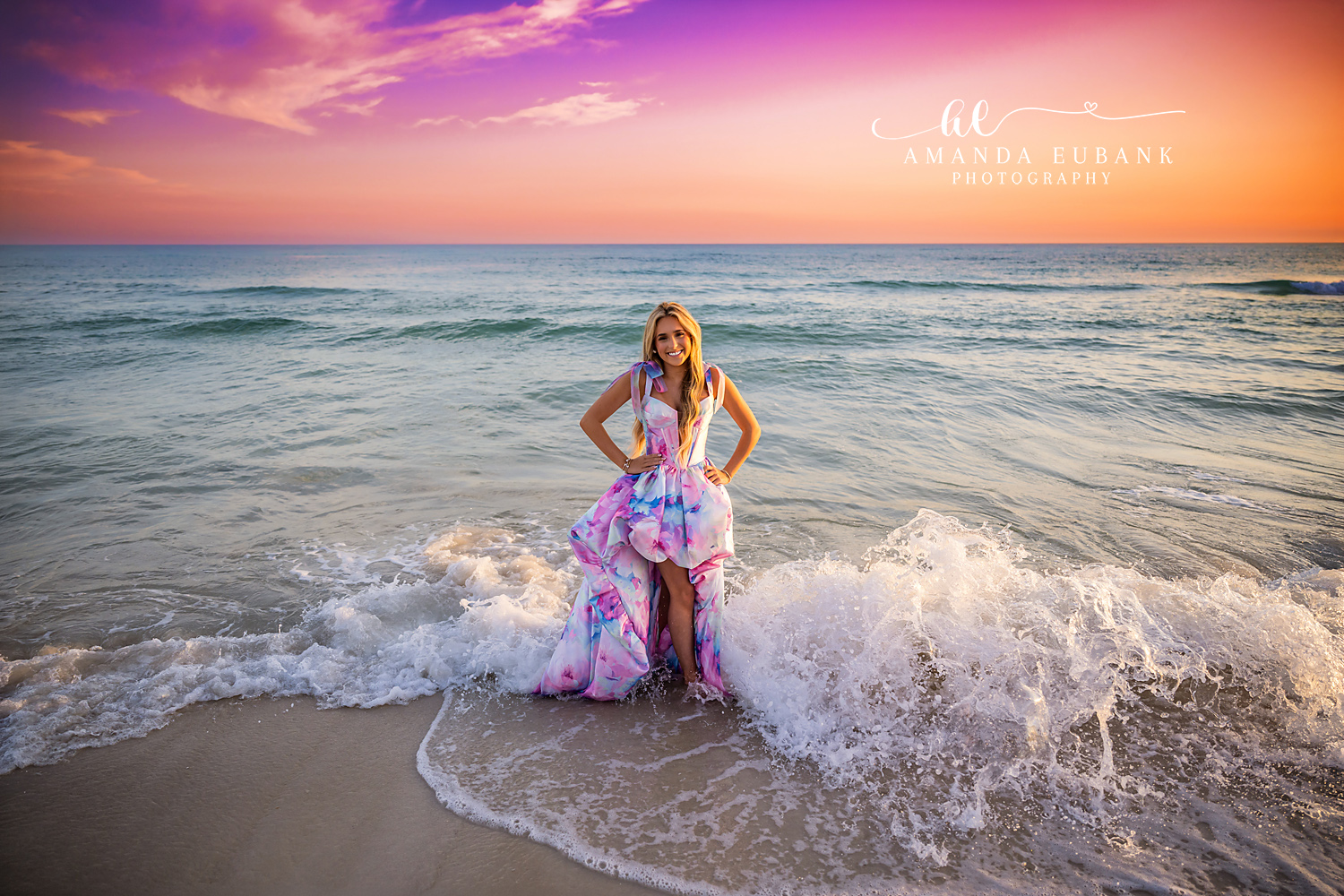 Confident Beach Senior Pose in the Surf | Senior Photographer in Alys Beach Senior posing confidently in the surf in a pastel watercolor gown at sunset, by Senior Photographer in Alys Beach Amanda Eubank.