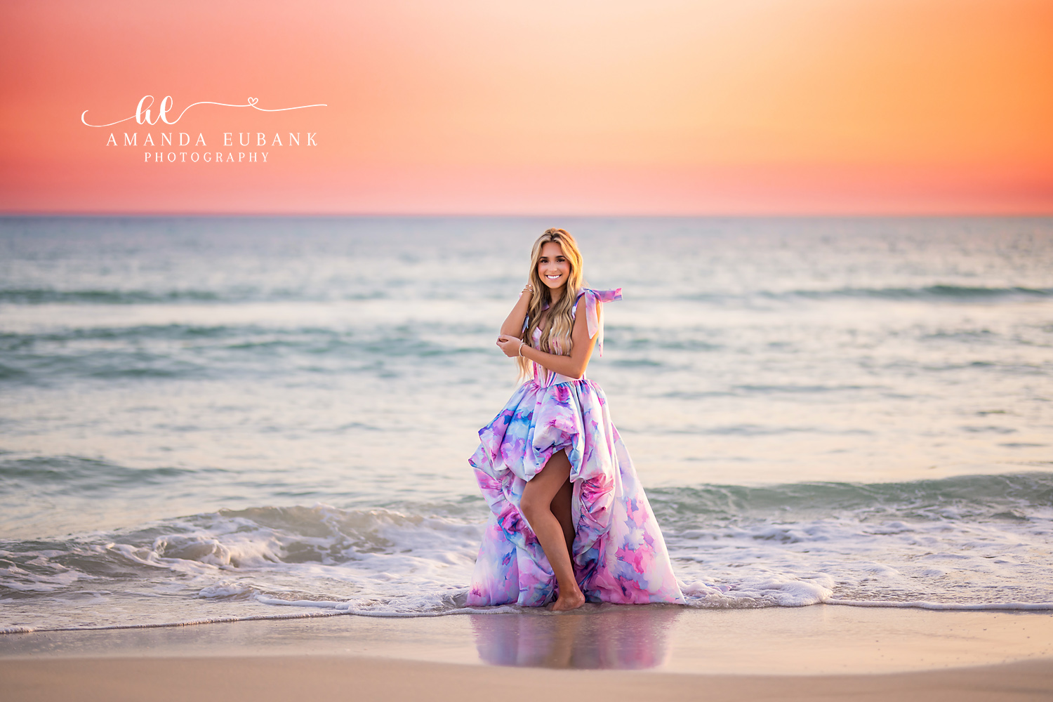 Pink Sunset Beach Senior Session | Alys Beach Senior Photographer Senior in a flowing pastel gown standing in the surf at pink sunset, photographed by Alys Beach Senior Photographer Amanda Eubank.