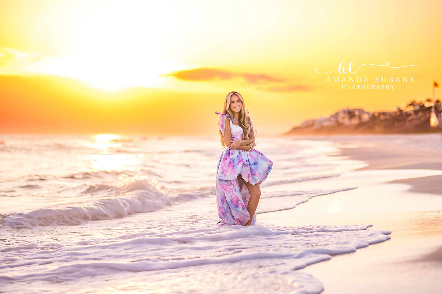 Golden Hour Beach Senior Portrait | Photographer in Alys Beach Senior in a flowing pastel dress standing in golden hour surf, captured by Photographer in Alys Beach Amanda Eubank.