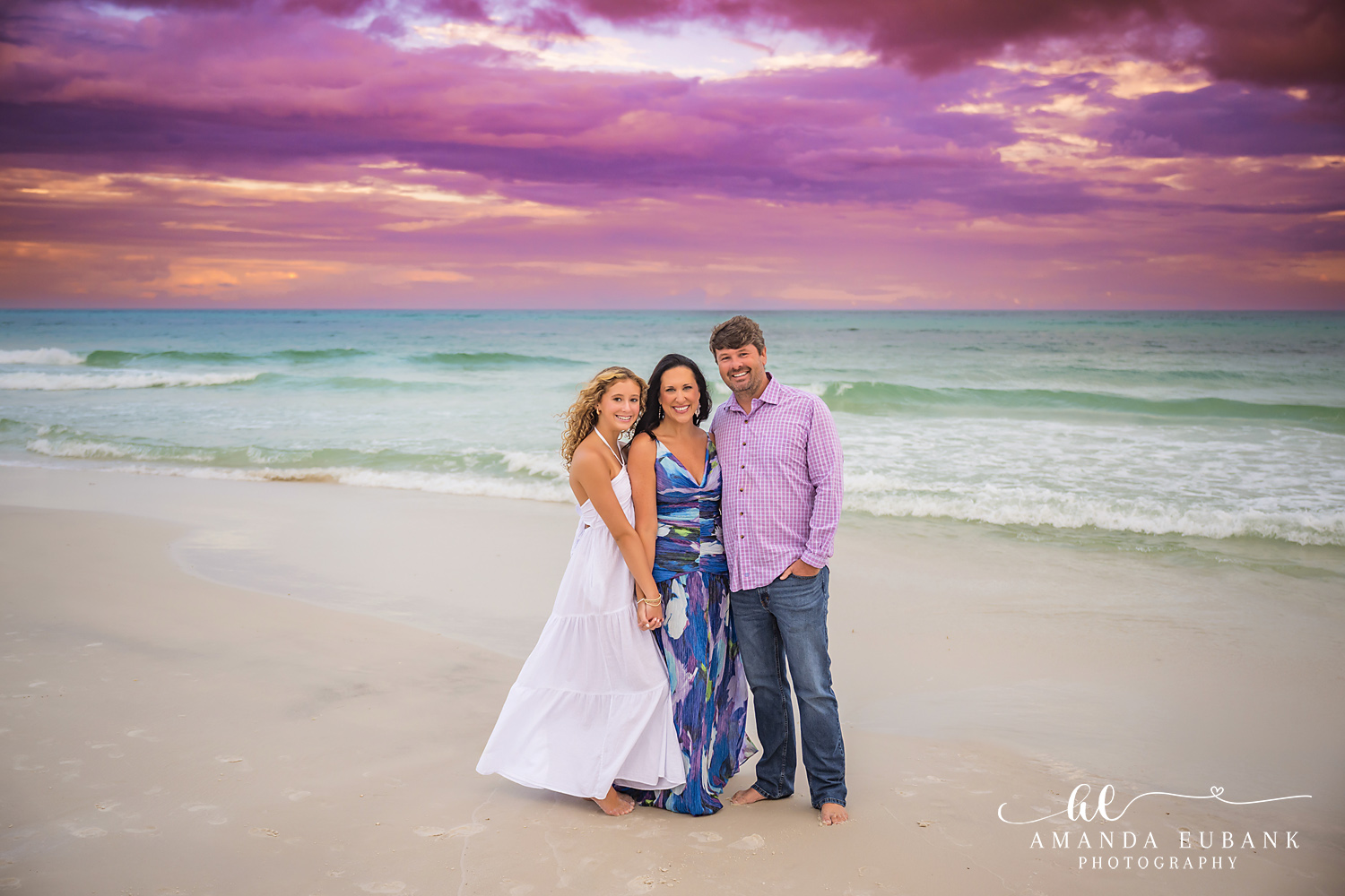 30A Beach Family Photos in Santa Rosa Beach at Golden Hour Wide beach portrait of three family members on Seagrove Beach under a magenta 30A sunset