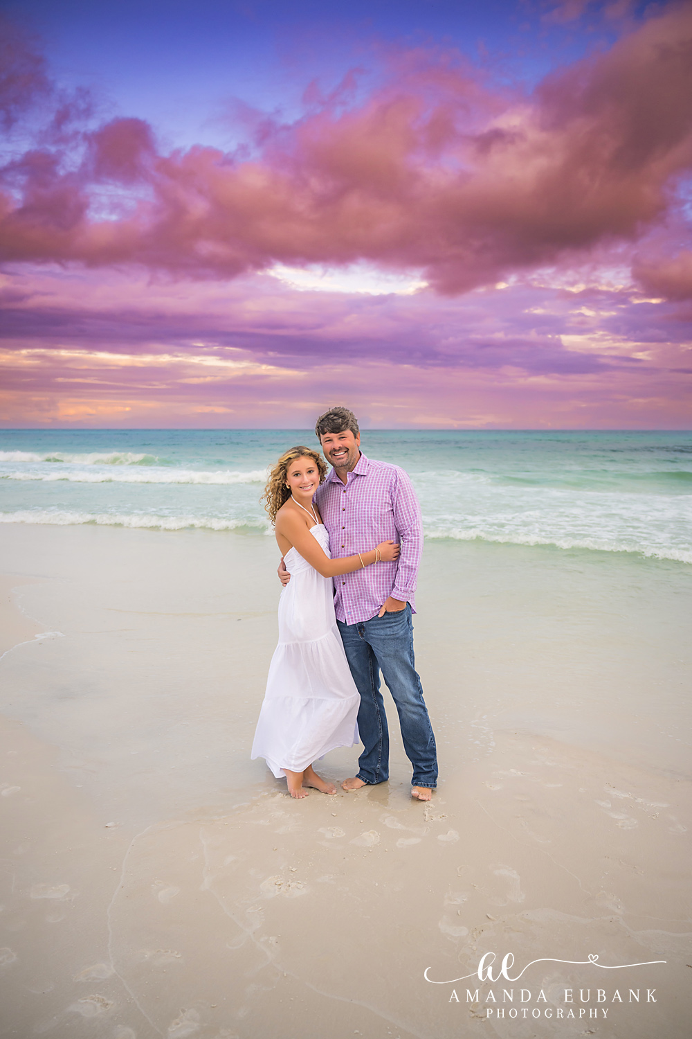 Santa Rosa Beach Sunset Portrait on the 30A Shoreline Man in a lavender check shirt and girl in a white maxi dress on the 30A sand at sunset