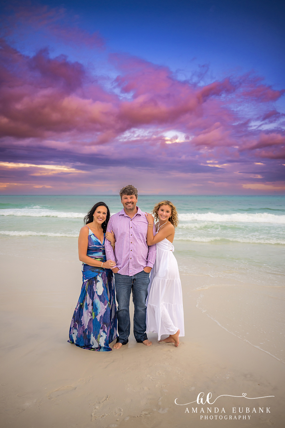 Santa Rosa Beach Family Photos with a Purple Gulf Sunset Family portrait on the wet sand at Seagrove Beach with emerald Gulf water and a purple sunset