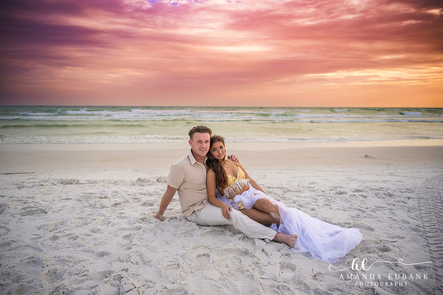 Dune Allen Beach Couples Photographer – Sunset Portrait on 30A Couple sitting together on the sand at Dune Allen Beach during a fiery 30A sunset