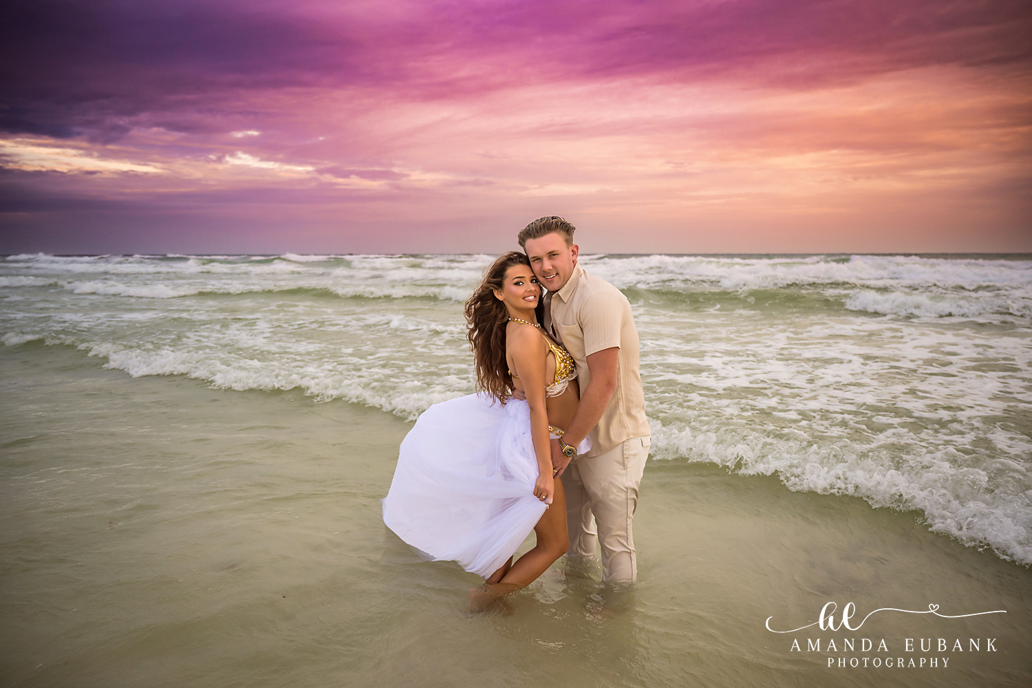 30A Beach Couples Session Standing in the Gulf Surf Couple in the waves at sunset, tulle skirt floating on the water at Dune Allen Beach
