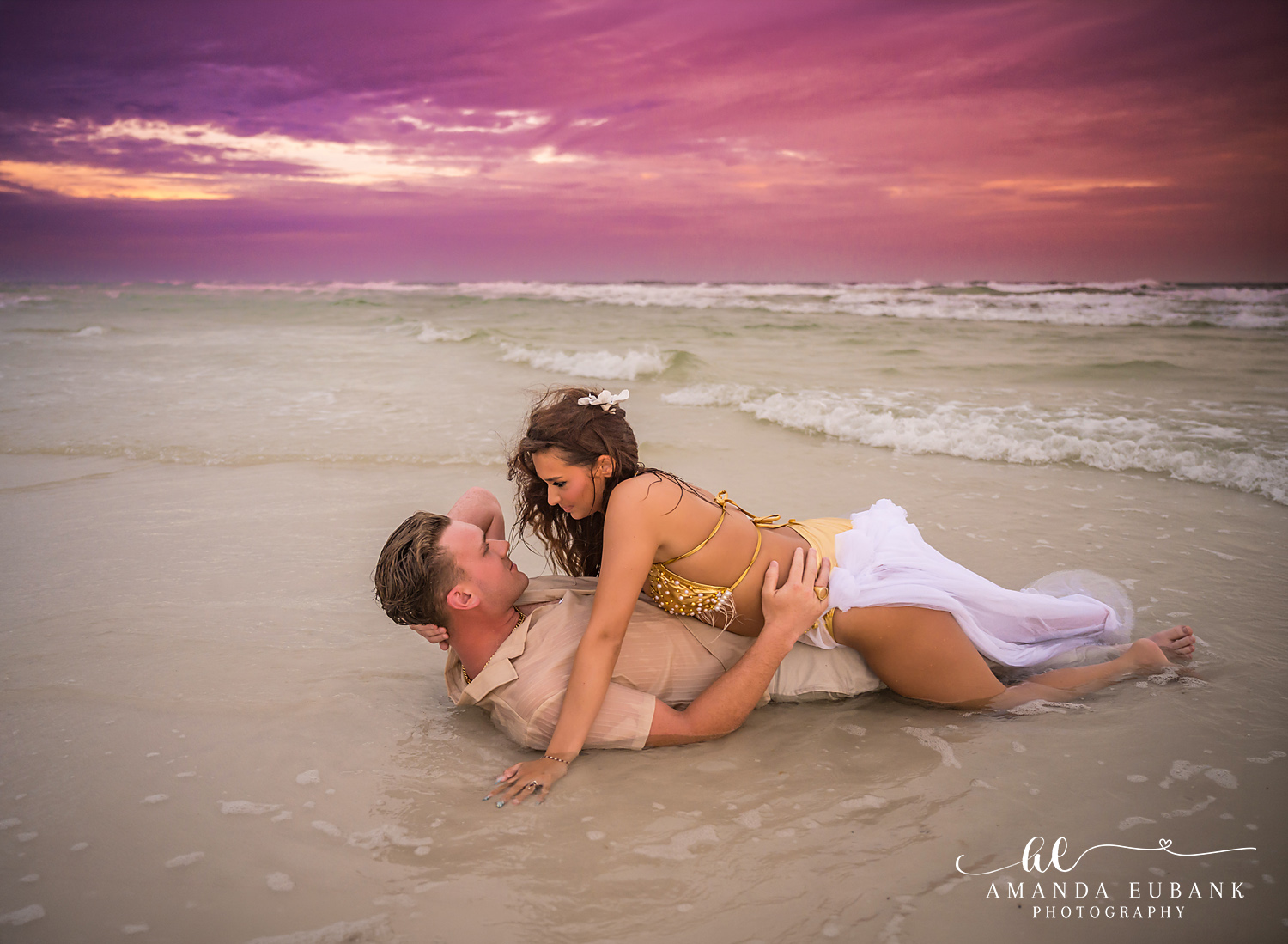Dune Allen Beach Anniversary Session in the Shallow Water Couple lying together in the shallow wash of the surf at sunset on 30A