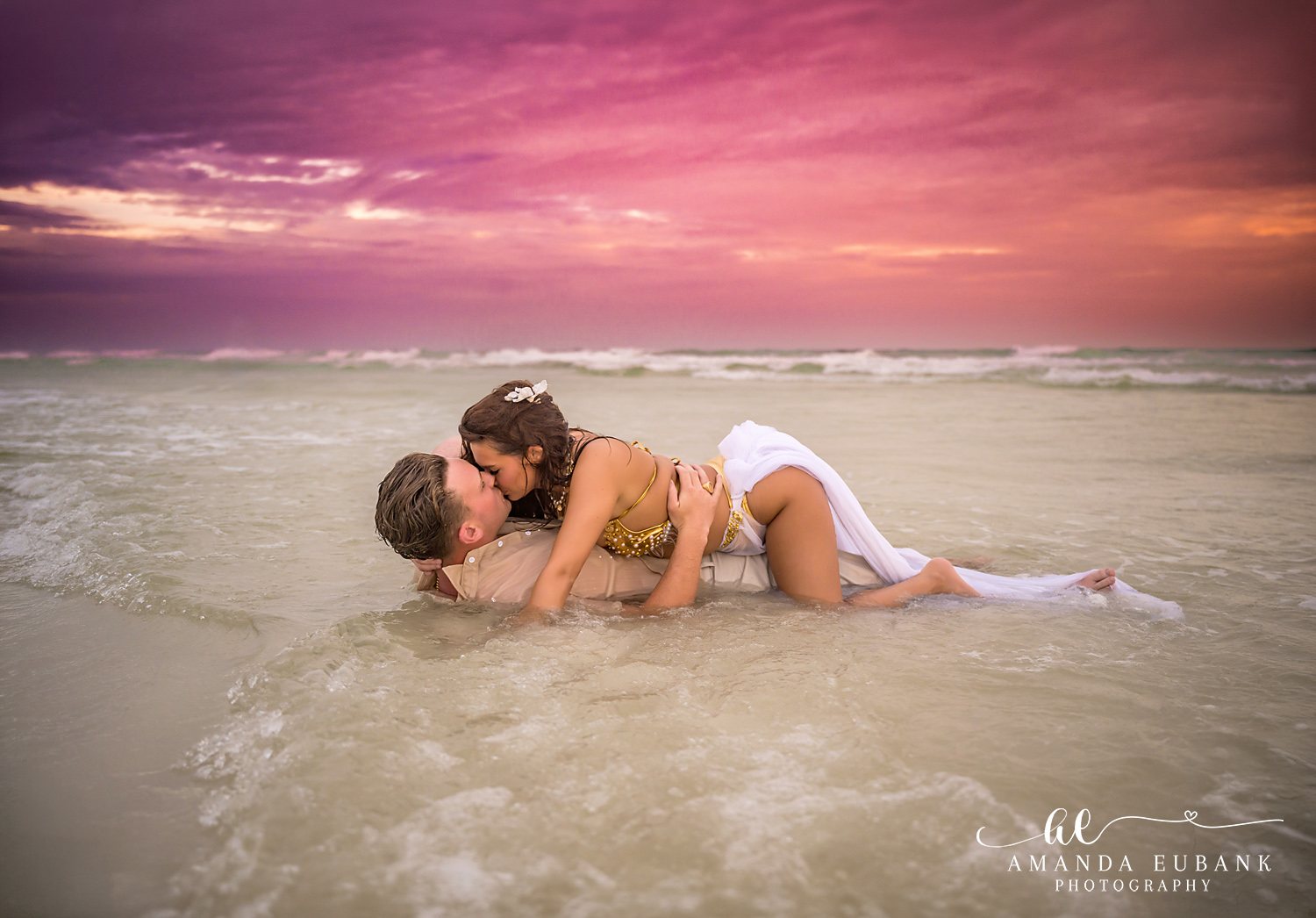 30A Couples Photographer – Kissing in the Surf at Dune Allen Beach Couple kissing in the shallow water at the end of a Dune Allen Beach sunset session