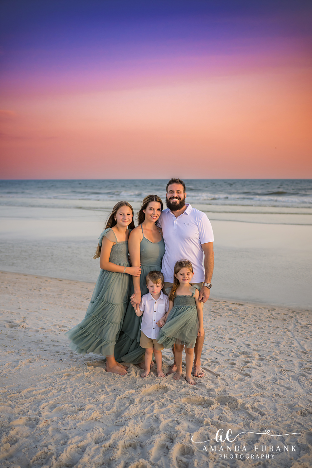 Carillon Beach Photographer – Family Group Portrait at Sunset Family posing together on the beach at sunset in Carillon Beach, Florida