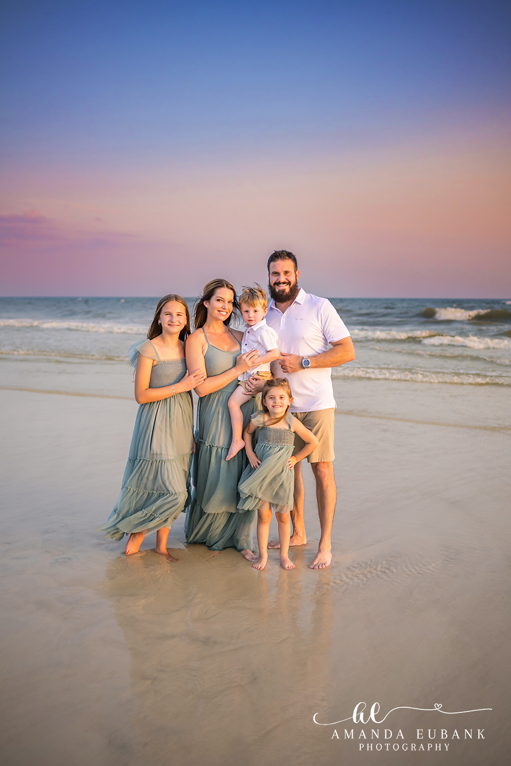 Carillon Beach Photographer – Family Portrait Along the Gulf Family standing together along the Gulf shoreline in Carillon Beach, Florida