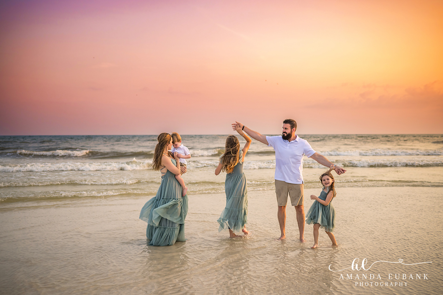 Carillon Beach Photographer – Family Playing in the Waves Family of four playing together in the waves in Carillon Beach, Florida
