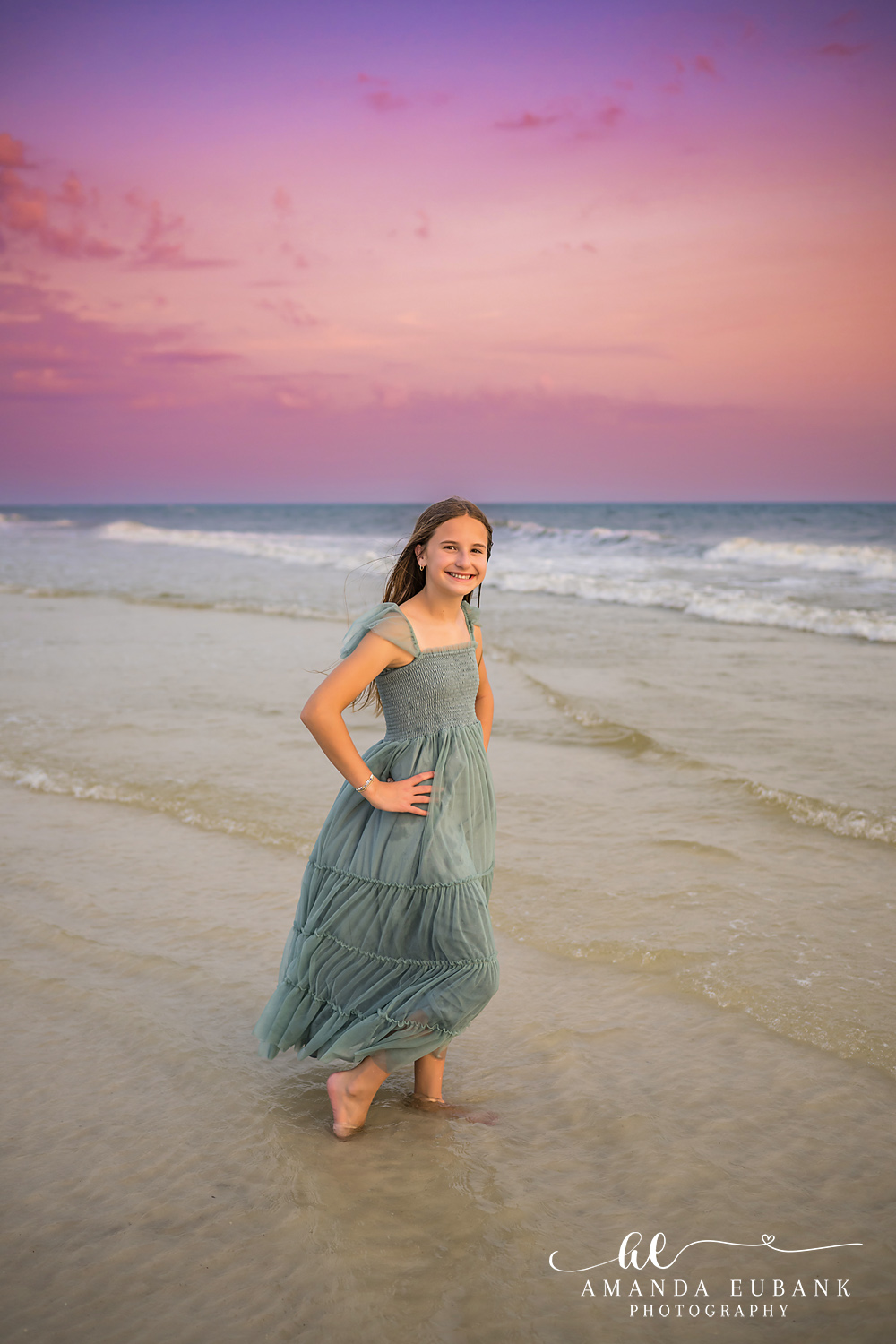 Carillon Beach Photographer – Walking Through the Shallow Waves Girl in a sage green dress walking through shallow waves in Carillon Beach, Florida