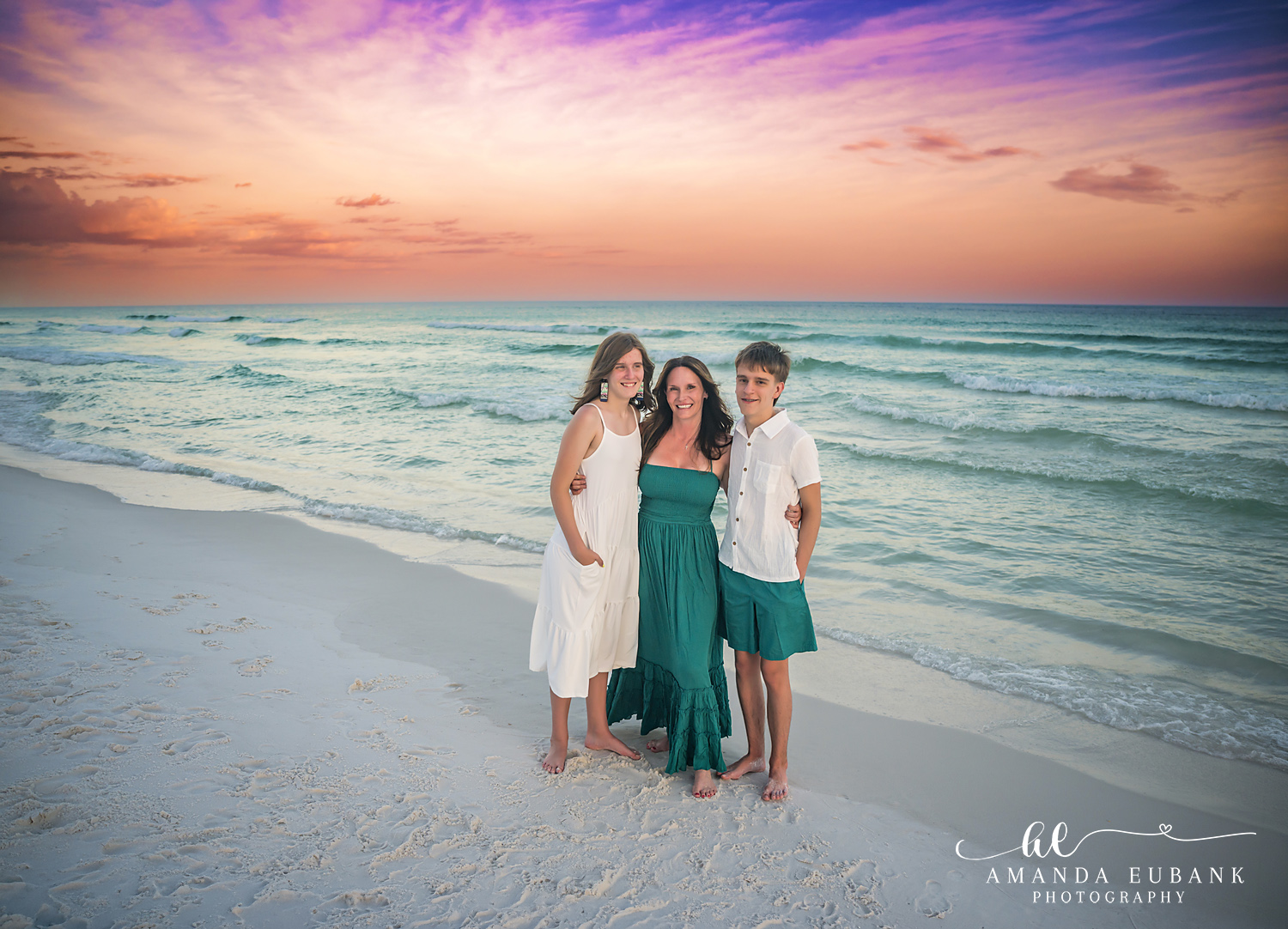 Destin Family Photographer – Family of Three at Sunset Mother and two children posing together on the beach in Destin, Florida