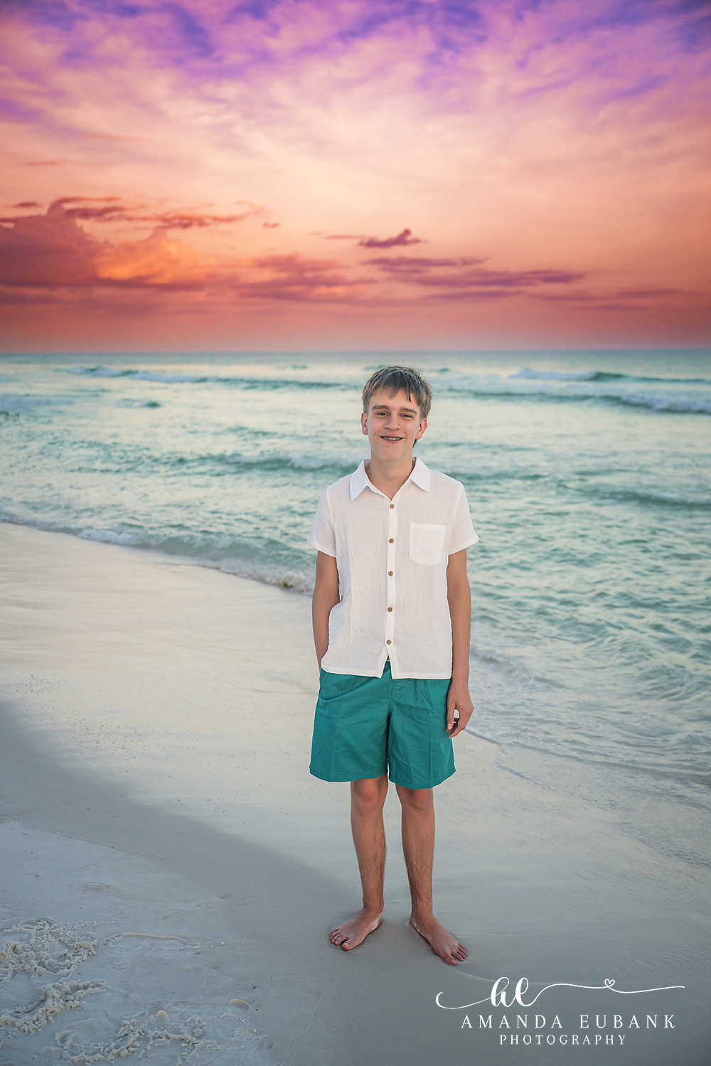 Destin Family Photographer – Young Son Watching the Waves Young boy in a white shirt standing on the beach watching the waves in Destin, Florida